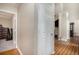 Hallway with hardwood floors and neutral paint leading to other rooms in the home at 1907 S Van Wert Rd, Villa Rica, GA 30180