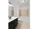 Clean bathroom with black cabinets, double sink, tub and shower combination at 3040 Peachtree Nw Rd # 1501, Atlanta, GA 30305