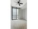 Bright bedroom featuring carpet, ceiling fan, and sliding glass door to the balcony at 3040 Peachtree Nw Rd # 1501, Atlanta, GA 30305