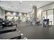 A spacious gym with modern exercise machines, mirrored walls, and ceiling fans at 3040 Peachtree Nw Rd # 1501, Atlanta, GA 30305
