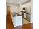 Modern kitchen featuring stainless steel appliances and a large island with sink at 3040 Peachtree Nw Rd # 1501, Atlanta, GA 30305