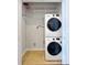 Laundry room with stacked washer and dryer with wire shelving at 3040 Peachtree Nw Rd # 1501, Atlanta, GA 30305