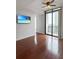 Open living room with hardwood floors, ceiling fan, and balcony access, perfect for entertaining at 3040 Peachtree Nw Rd # 1501, Atlanta, GA 30305