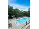 Features a swimming pool with in-pool lounge chairs and tables with blue umbrellas at 3040 Peachtree Nw Rd # 1501, Atlanta, GA 30305