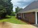Brick home exterior featuring a fenced yard and a well-maintained lawn and landscaping at 512 Ollas Walk, Mcdonough, GA 30252