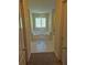 Bright bathroom featuring a large soaking tub and white tile flooring at 512 Ollas Walk, Mcdonough, GA 30252