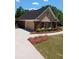 Home featuring a driveway and landscaped front yard with a mixture of lawn and bushes at 512 Ollas Walk, Mcdonough, GA 30252