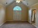 Spacious bedroom with large arched window, shuttered blinds, and ensuite access at 512 Ollas Walk, Mcdonough, GA 30252