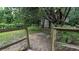 View of backyard with fenced in area and mature trees offering tons of privacy at 5710 Cardigan Trce, Sugar Hill, GA 30518