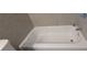 Clean, bright bathroom featuring a tub and tile surround at 5710 Cardigan Trce, Sugar Hill, GA 30518