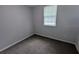 Bedroom featuring neutral walls, grey carpet and a window with natural light at 5710 Cardigan Trce, Sugar Hill, GA 30518