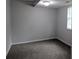 Neutral bedroom features grey carpet and natural light from a window at 5710 Cardigan Trce, Sugar Hill, GA 30518