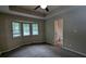 Bedroom with neutral walls and carpet and ample lighting at 5710 Cardigan Trce, Sugar Hill, GA 30518