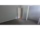 Neutral bedroom showcasing gray carpet, white doors, and natural light at 5710 Cardigan Trce, Sugar Hill, GA 30518