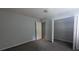 Clean bedroom features grey walls, carpeted floor, and an open closet at 5710 Cardigan Trce, Sugar Hill, GA 30518