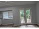 Bright dining area with modern floors and double doors to a deck at 5710 Cardigan Trce, Sugar Hill, GA 30518