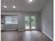 Bright dining area with modern floors and double doors to a deck at 5710 Cardigan Trce, Sugar Hill, GA 30518