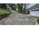 Long driveway leading up to a house with a retaining wall on one side, showcasing the property's approach at 5710 Cardigan Trce, Sugar Hill, GA 30518