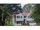 Charming two-story home with an attached garage surrounded by mature trees at 5710 Cardigan Trce, Sugar Hill, GA 30518