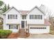 Charming two-story home with an attached garage and inviting front porch steps at 5710 Cardigan Trce, Sugar Hill, GA 30518
