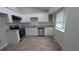 Modern kitchen featuring new stainless appliances, granite counters and sleek white cabinetry at 5710 Cardigan Trce, Sugar Hill, GA 30518