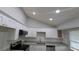 Bright kitchen showcasing recessed lighting, stainless steel appliances, and ample storage space at 5710 Cardigan Trce, Sugar Hill, GA 30518
