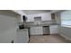 Newly remodeled kitchen features white cabinets, stainless steel appliances, and granite countertops at 5710 Cardigan Trce, Sugar Hill, GA 30518