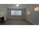 Spacious living room with fireplace, ceiling fan and plenty of natural light at 5710 Cardigan Trce, Sugar Hill, GA 30518