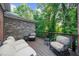 Comfortable outdoor deck featuring cozy seating and serene views of the surrounding green foliage at 5968 Reddington Way, Sandy Springs, GA 30328