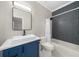 Bathroom featuring modern blue vanity and geometric shower tile at 5968 Reddington Way, Sandy Springs, GA 30328