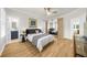 Bright bedroom features hardwood floors, stylish decor, and access to an en-suite bathroom for convenience at 5968 Reddington Way, Sandy Springs, GA 30328