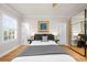 Bedroom featuring hardwood floors, shutters, and neutral decor at 5968 Reddington Way, Sandy Springs, GA 30328