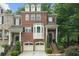 Charming brick townhome with a two-car garage and manicured landscaping at 5968 Reddington Way, Sandy Springs, GA 30328