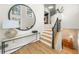Bright foyer featuring staircase, hardwood floors, decorative mirror and natural light at 5968 Reddington Way, Sandy Springs, GA 30328