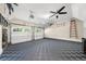 Clean and organized garage with finished floors, storage racks and a ceiling fan for climate control at 5968 Reddington Way, Sandy Springs, GA 30328