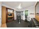 Home gym featuring weightlifting equipment, wood accent wall and ample lighting at 5968 Reddington Way, Sandy Springs, GA 30328