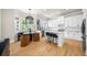 Bright kitchen with white cabinetry, stainless steel appliances, and breakfast nook at 5968 Reddington Way, Sandy Springs, GA 30328