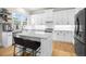 Kitchen features an island with seating, modern cabinets, and stainless steel appliances at 5968 Reddington Way, Sandy Springs, GA 30328