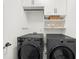 Laundry room with modern black front load washer and dryer and white cabinets at 5968 Reddington Way, Sandy Springs, GA 30328