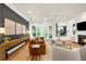 Bright living area features hardwood floors, a cozy fireplace, and glass doors leading to outdoor living space at 5968 Reddington Way, Sandy Springs, GA 30328