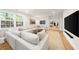 Bright living room features a large sectional sofa and open layout at 5968 Reddington Way, Sandy Springs, GA 30328