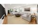 Spacious living room features a large sectional sofa, hardwood floors, and a light-filled seating area at 5968 Reddington Way, Sandy Springs, GA 30328