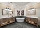 Symmetrical bathroom with dual vanities, large mirrors, stylish sconces, and a luxurious soaking tub at 5968 Reddington Way, Sandy Springs, GA 30328