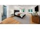 This main bedroom features hardwood floors, a seating area, and natural light streaming through multiple windows at 5968 Reddington Way, Sandy Springs, GA 30328
