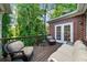 Relax on this wooden deck, complete with comfortable seating and a beautiful view of the trees and foliage at 5968 Reddington Way, Sandy Springs, GA 30328