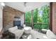 Covered porch with seating area and views of the surrounding trees at 5968 Reddington Way, Sandy Springs, GA 30328