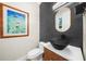 Modern powder room with stylish mirror, vessel sink, and neutral wall art at 5968 Reddington Way, Sandy Springs, GA 30328