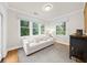 Bright sitting room filled with light from generous windows and a plush sofa, a perfect reading nook at 5968 Reddington Way, Sandy Springs, GA 30328