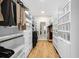 Spacious walk-in closet with custom shelving and hardwood floors at 5968 Reddington Way, Sandy Springs, GA 30328