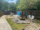 View of the backyard fire pit, including seating and a gravel area at 6701 Knollwood Cir, Douglasville, GA 30135